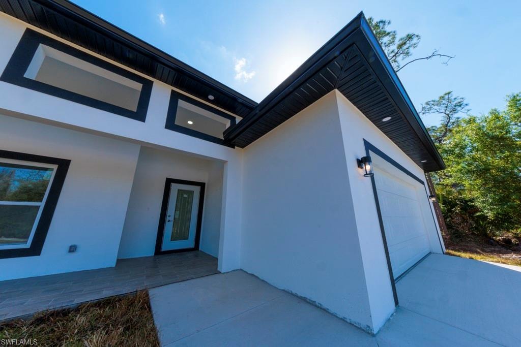 Modern exterior featuring white stucco and contrasting black trim