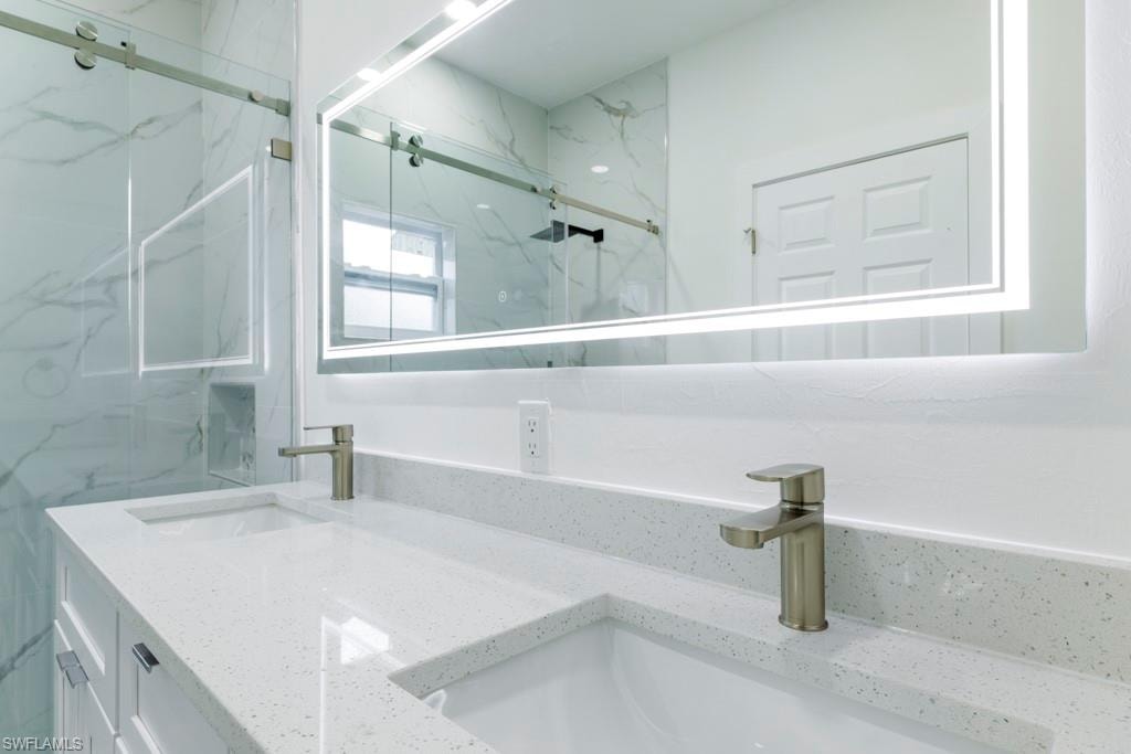 Dual vanity with integrated sinks and white speckled countertops