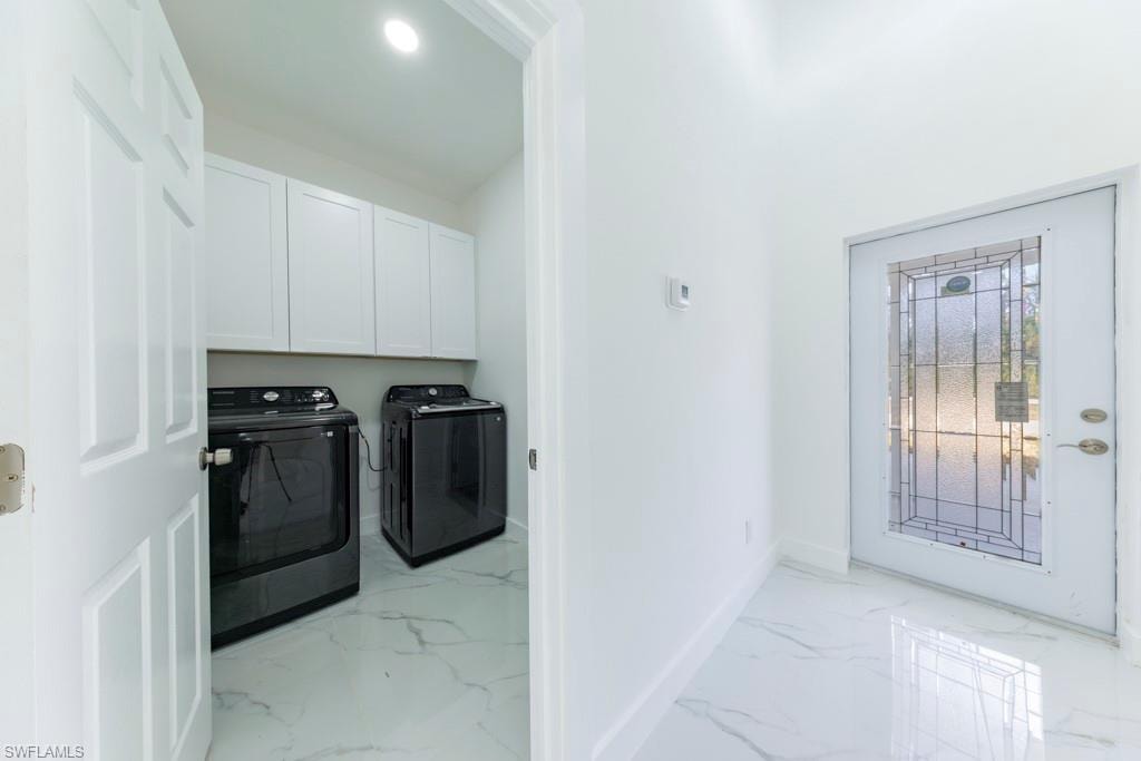 Entryway featuring a decorative glass door and white marble-look tile flooring