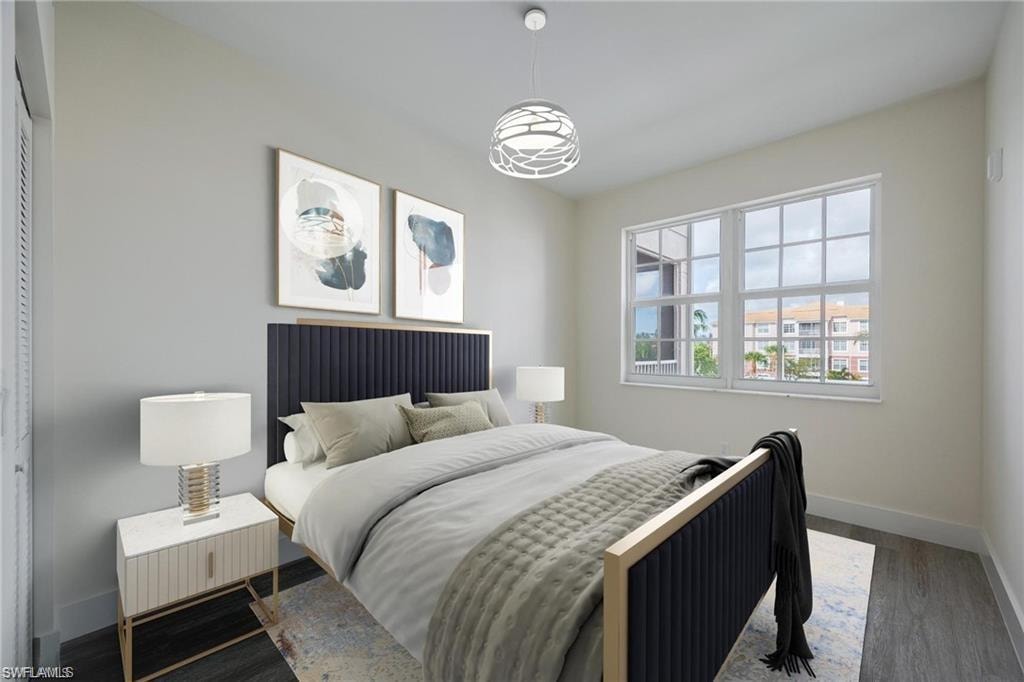 Bedroom with baseboards and wood finished floors