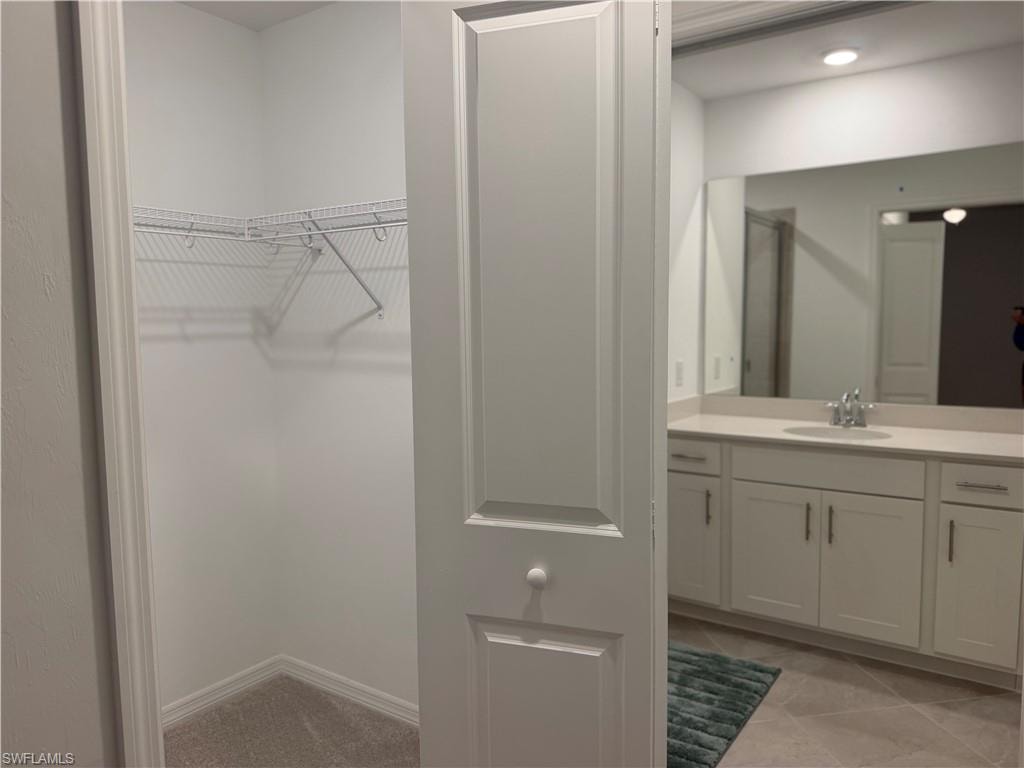 Closet leading to primary bathroom