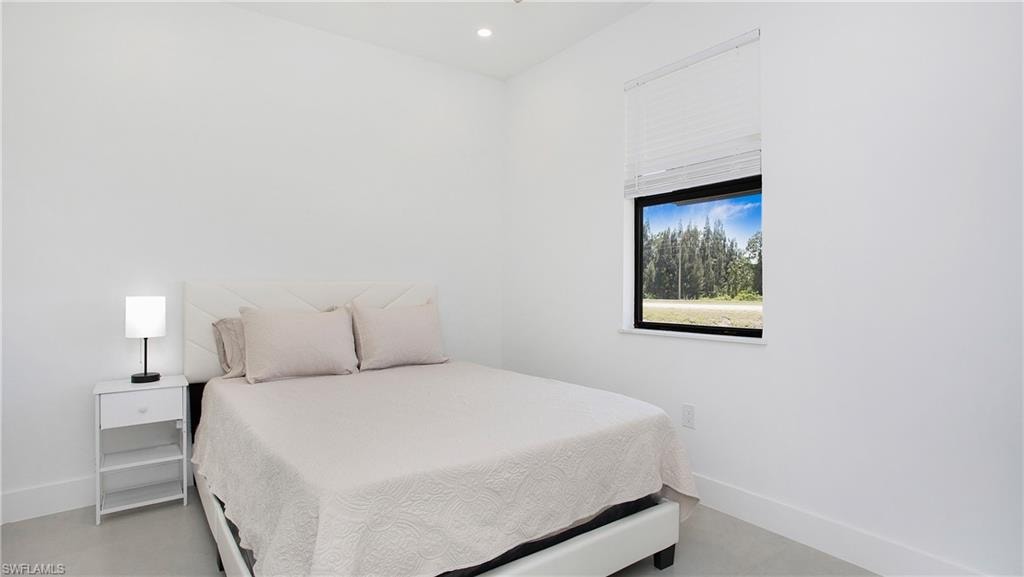 Crisp white walls with a window featuring horizontal blinds