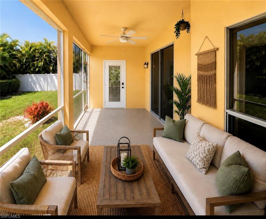 Screened lanai featuring concrete flooring and a ceiling fan