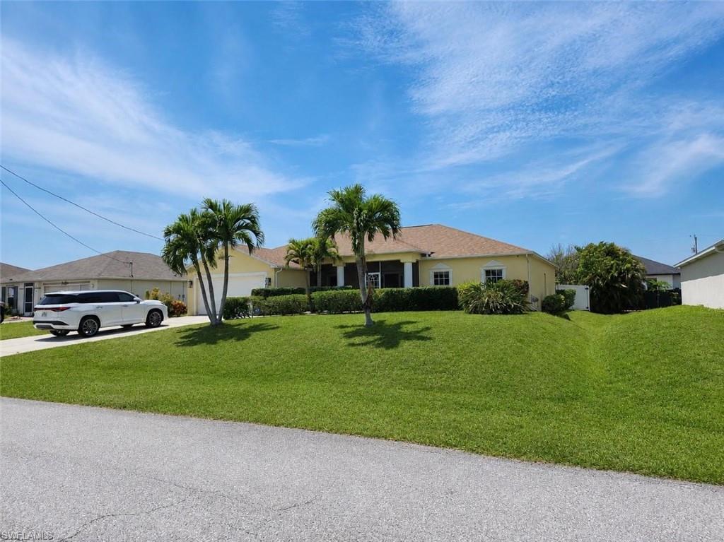 Single-story residence featuring a yellow exterior  with white decorative stucco bands. This home has a new roof as of 2025 The color of the roof  is a dimentional  shingle in shades of tan