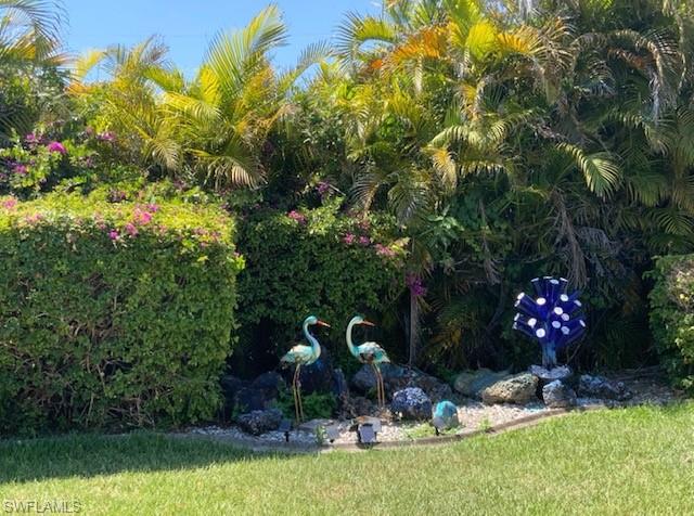 Lush landscaping with vibrant green hedges and mature palm trees