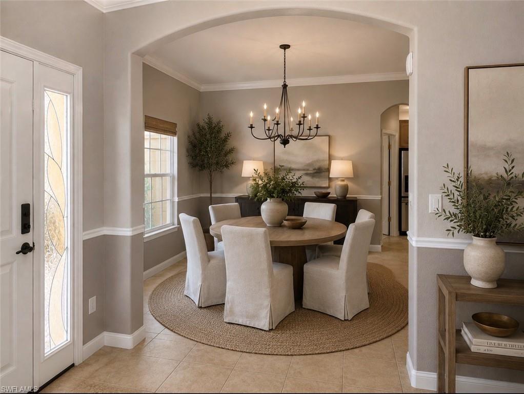 Dining area featuring a black chandelier and a round table