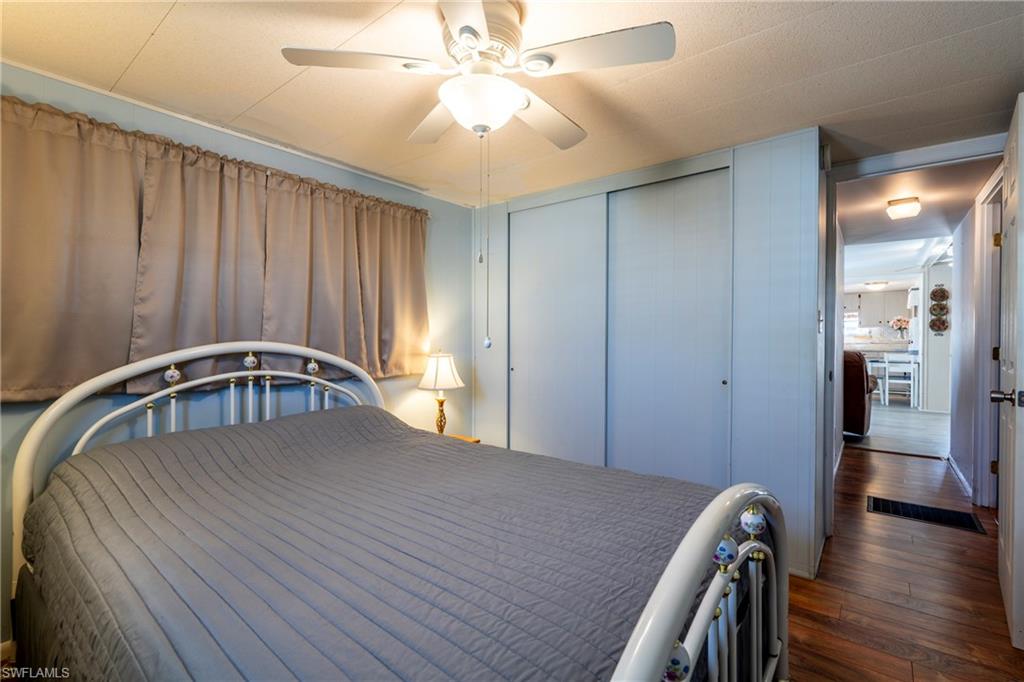 Bedroom featuring wood-style floors, a closet, and ceiling fan