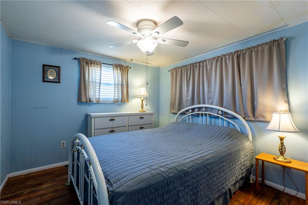 Bedroom with ceiling fan and wood-style floors
