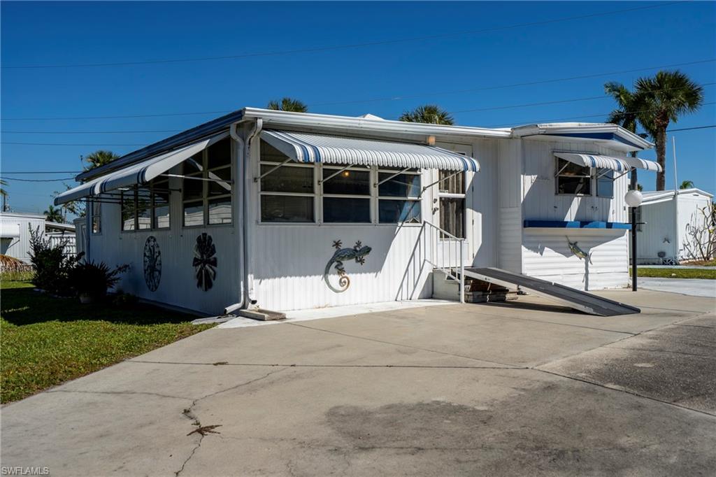 View of front of house, driveway, and wheelchair ramp