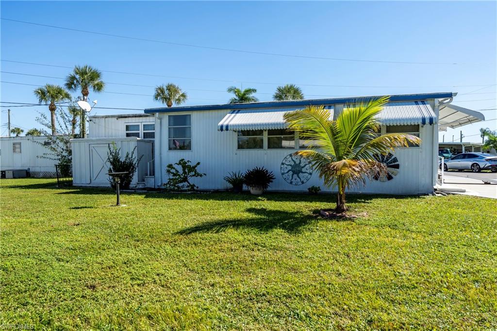 View of property exterior featuring a lawn