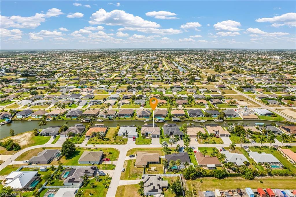Aerial perspective showcasing a residential area with canal access