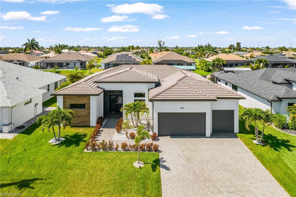 Modern single-story residence featuring a tile roof and clean white exterior