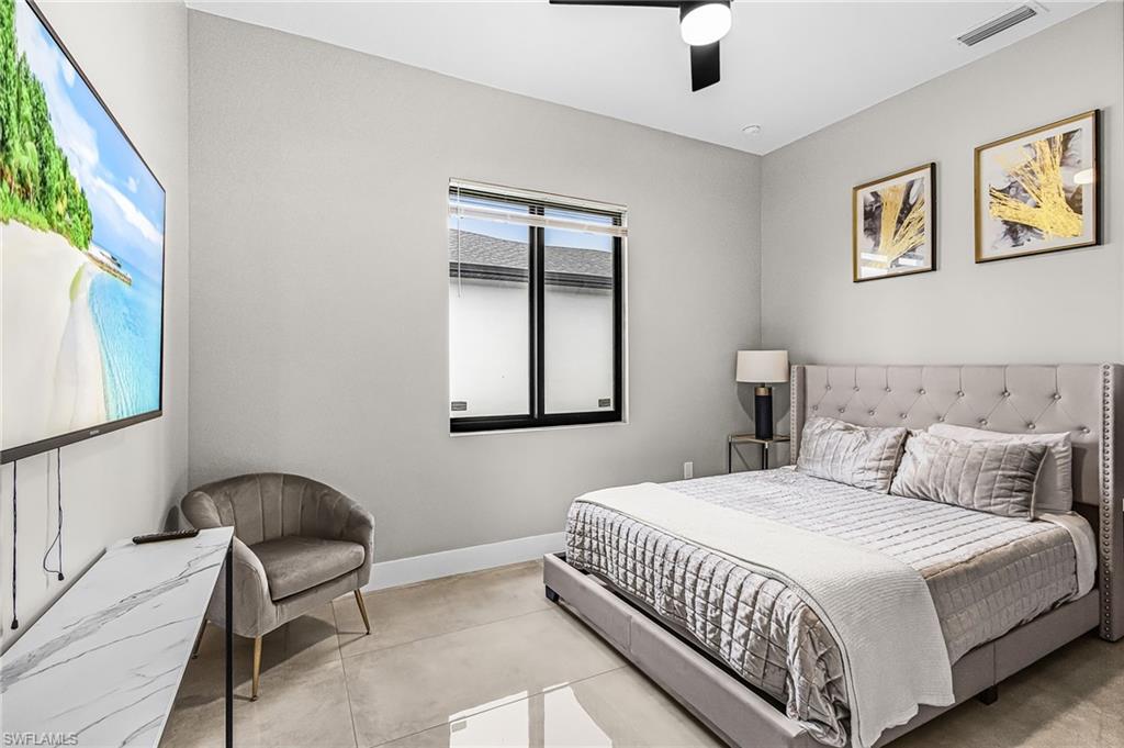 Recessed lighting illuminates the room, featuring a built-in window with horizontal blinds and a black ceiling fan