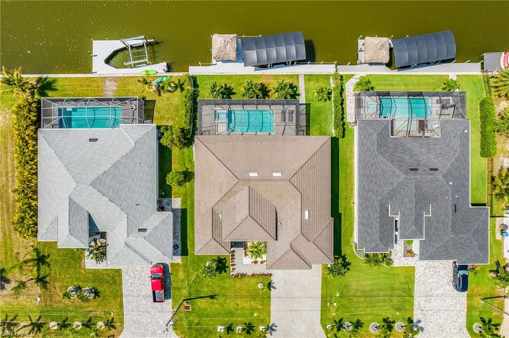 Three properties each featuring a private swimming pool, screened enclosure, and direct water frontage