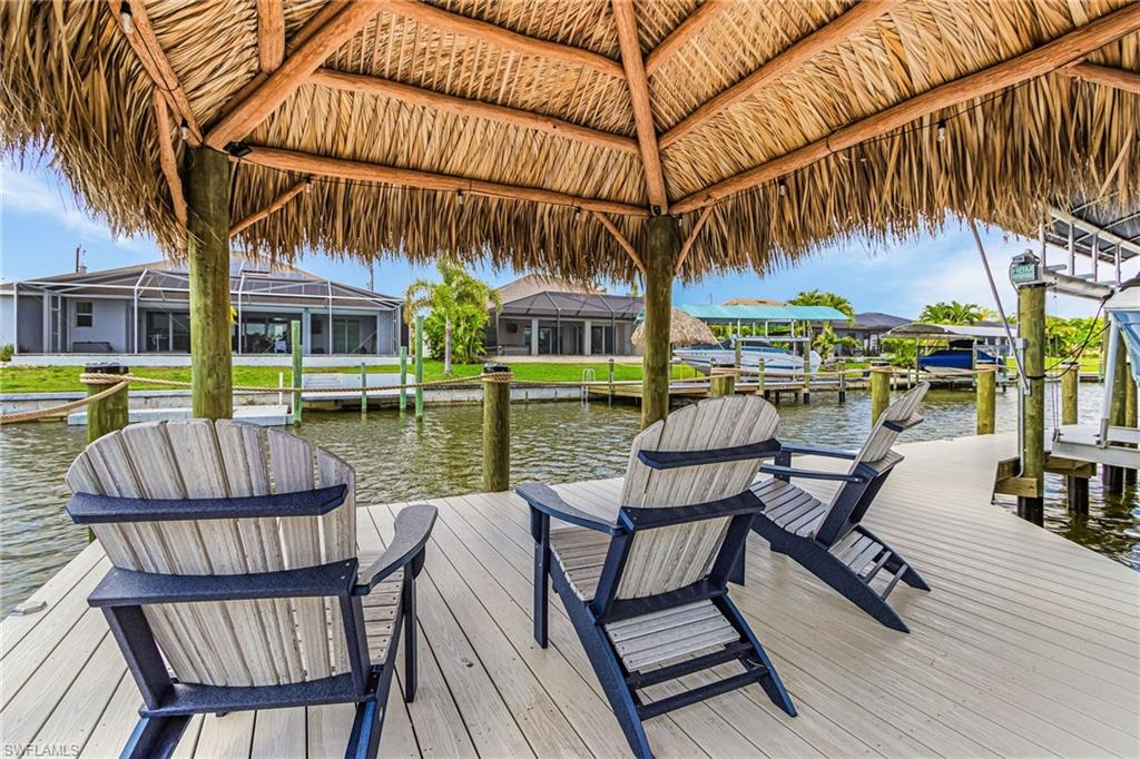 Thatched-roof tiki hut covering a waterside deck
