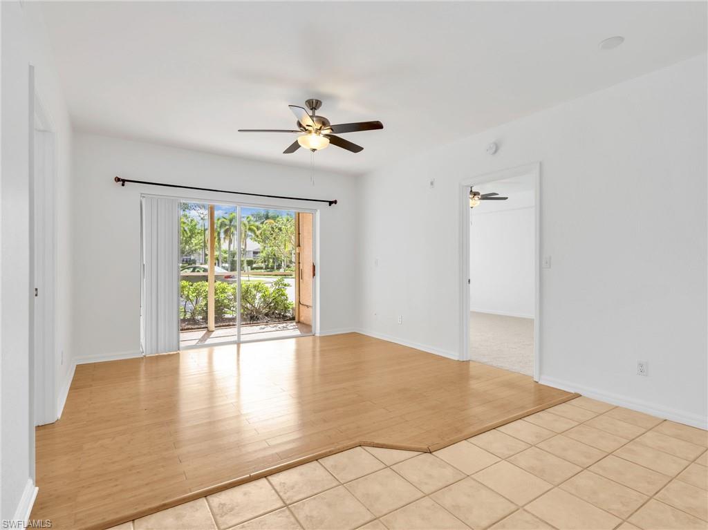 Living Room & Dining Area with Ceiling Fan and Sliders Leading to Screened In Lanai With Electric Hurricane Shutter