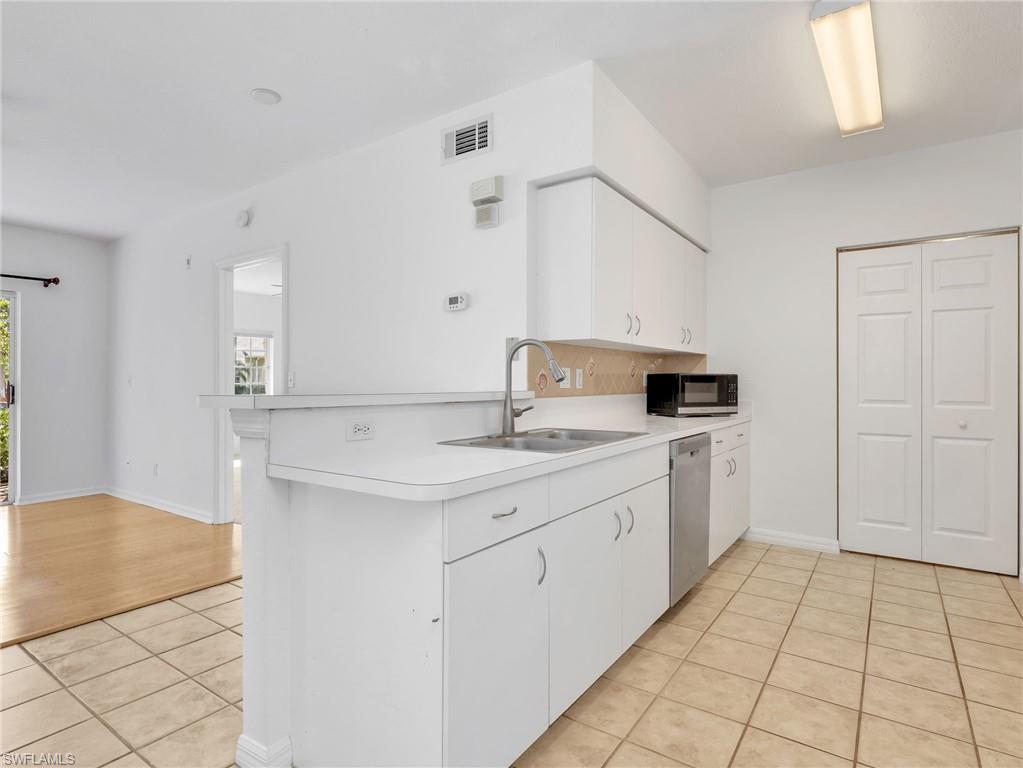 Kitchen with Tile Flooring, White Cabinetry, Stainless Steel Appliances Including new LG French Door Refrigerator & Range, Newer Whirlpool Dishwasher, Tile Backsplash & Pantry