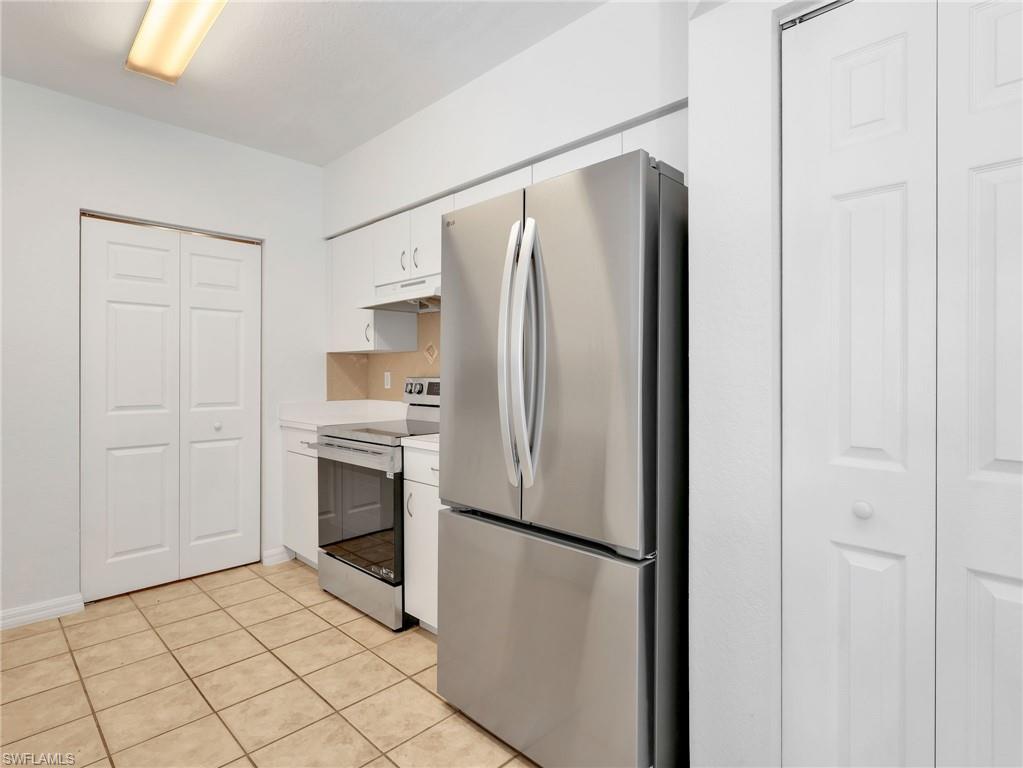 Kitchen with Tile Flooring, White Cabinetry, Stainless Steel Appliances Including new LG French Door Refrigerator & Range, Tile Backsplash & Pantry