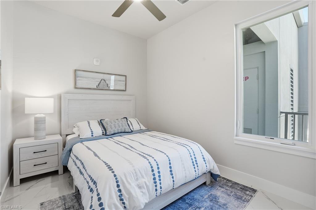 Bedroom with marble look tiles and ceiling fan - Virtually Edited Image