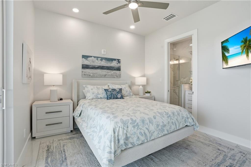 Bedroom with ensuite bathroom, a ceiling fan, and recessed lighting - Virtually Edited Image
