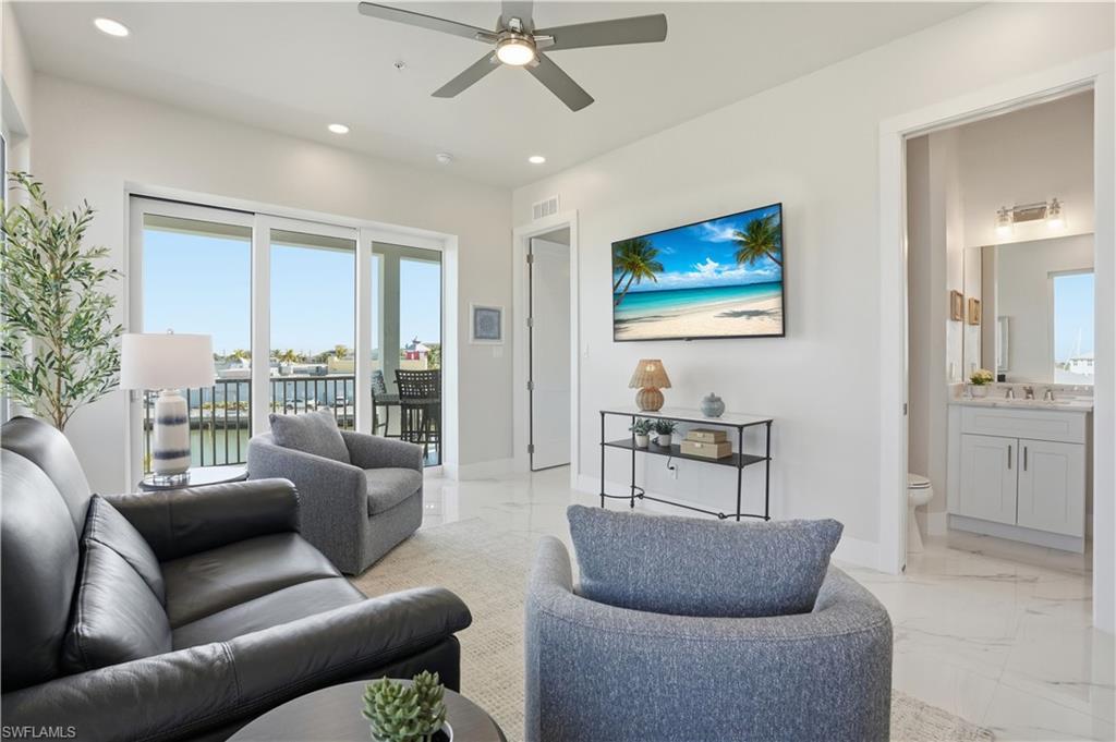 Living room with light marble finish floors, ceiling fan, and recessed lighting - Virtually Edited Image