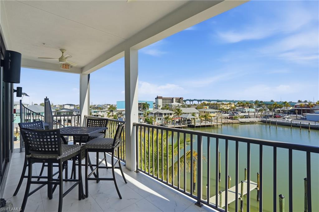 Balcony with a water view and ceiling fan - Virtually Edited Image