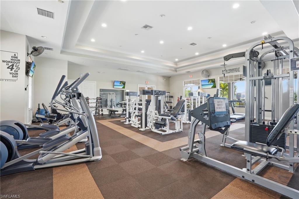 Dedicated fitness center featuring a variety of cardio and strength training equipment, recessed lighting, ceiling fans, and a checkerboard floor pattern