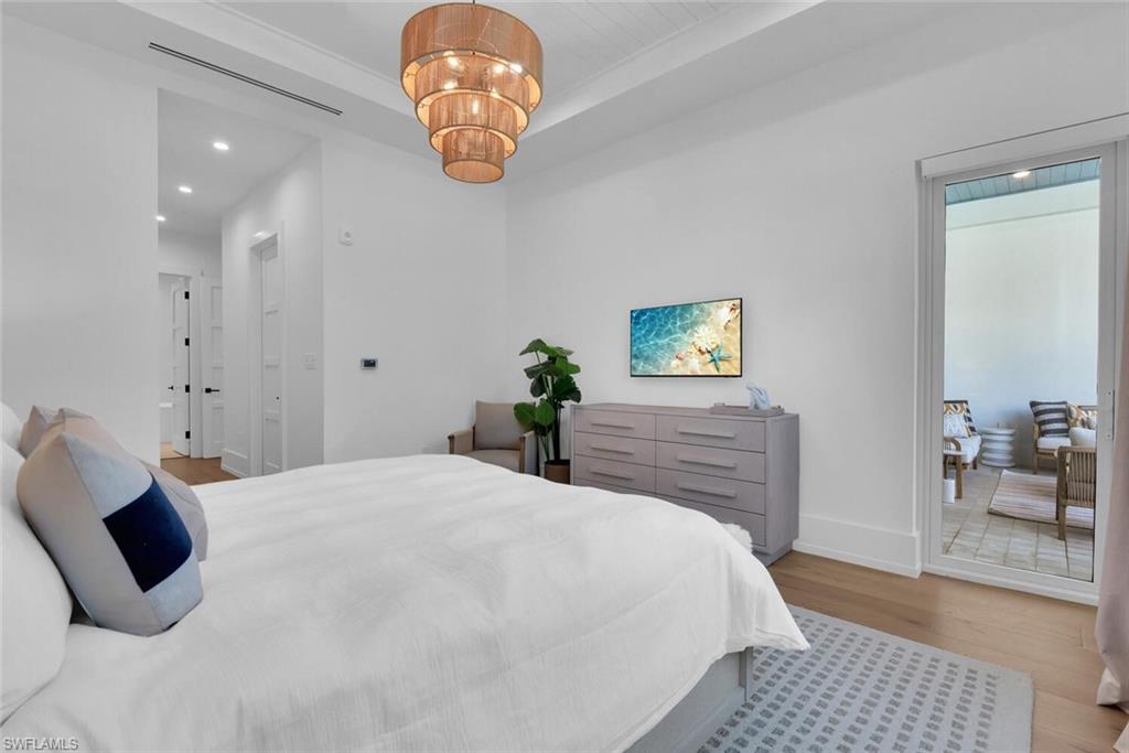 Bedroom featuring wood finished floors, baseboards, a chandelier, and recessed lighting