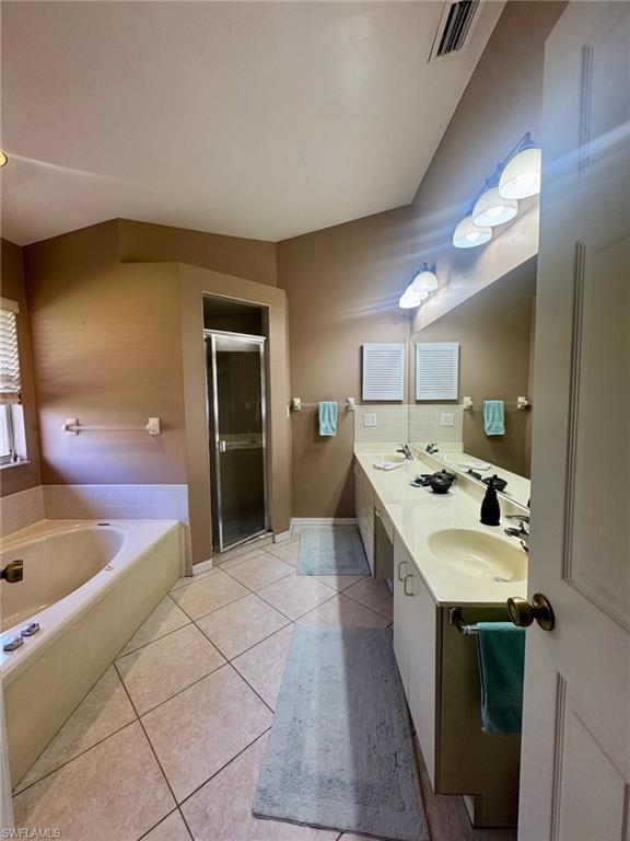 Primary bath with dual vanities and tile floors