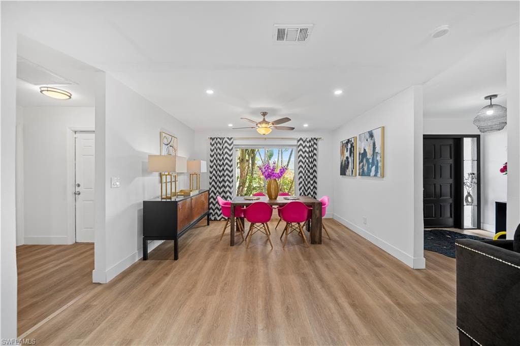 Bright interior with wood-finish flooring, recessed lighting, and a ceiling fan