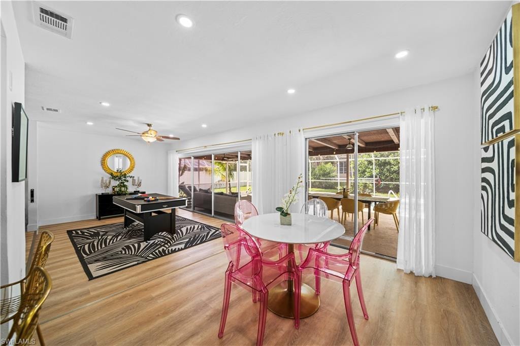 Open-concept room featuring wood-finish flooring, recessed lighting, and a ceiling fan
