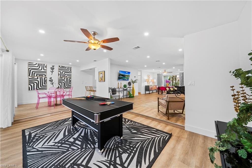 Open-concept interior featuring recessed lighting, a ceiling fan, and wood-finish flooring