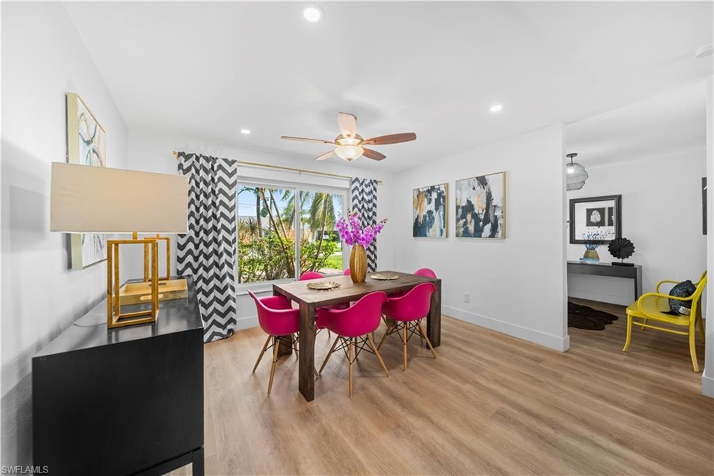 Dining area featuring wood-finish flooring, recessed lighting, and a ceiling fan