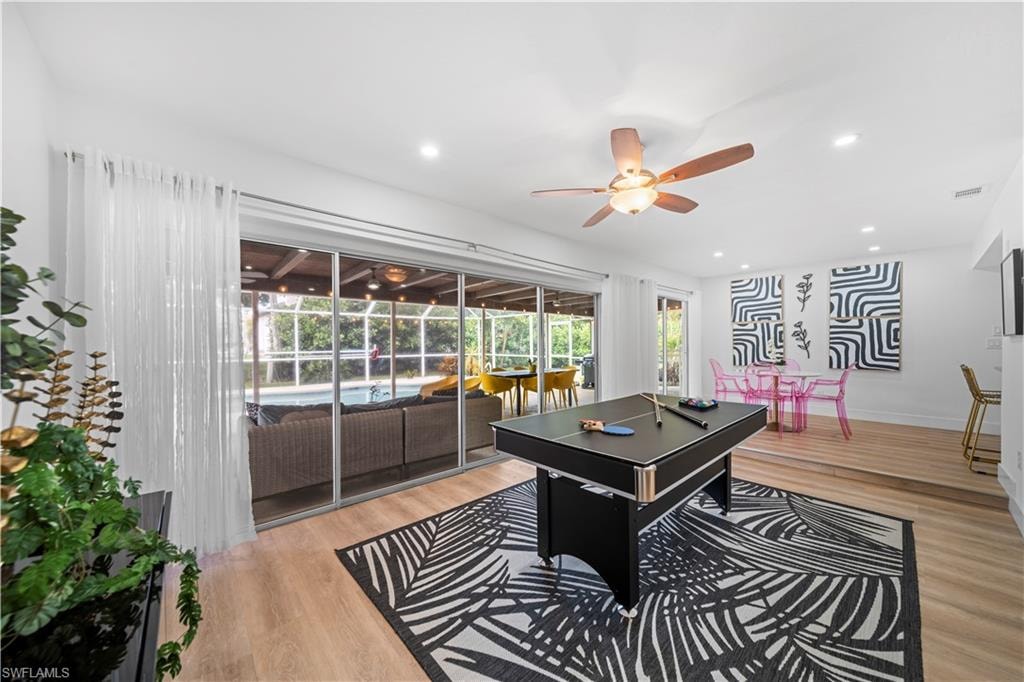 Spacious interior featuring wood-finish flooring, recessed lighting, and a ceiling fan