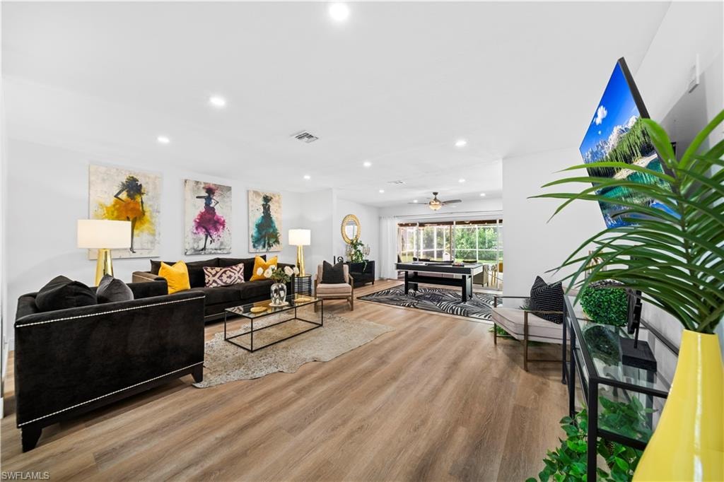 Spacious interior featuring wood-finish flooring, recessed lighting, and a neutral color palette