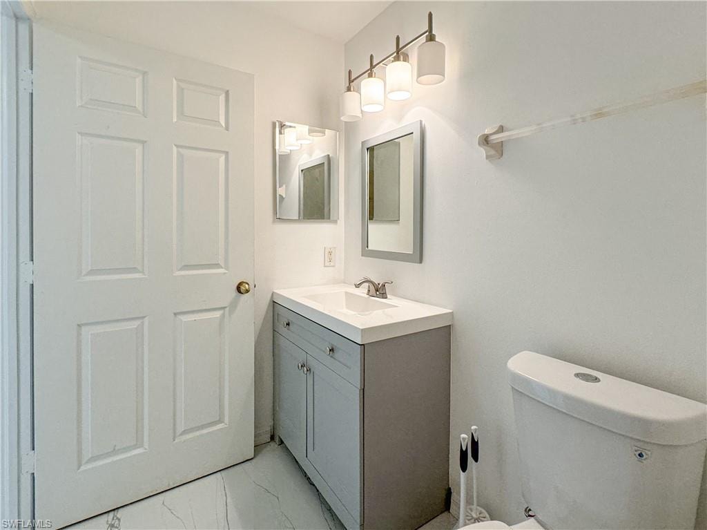 Bathroom with tile patterned flooring, vanity, and toilet