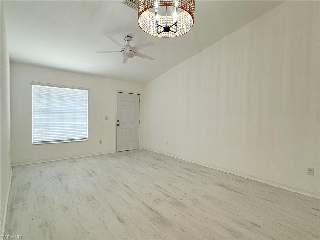 Unfurnished room featuring ceiling fan, light hardwood / wood-style floors, and lofted ceiling