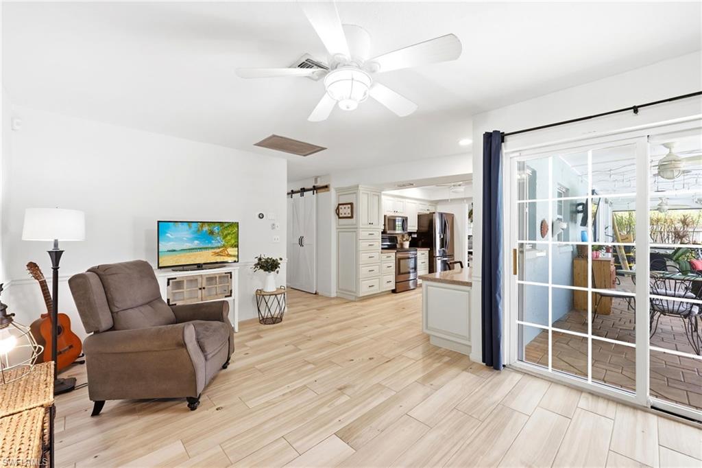 Family room w view of kitchen and pool patio