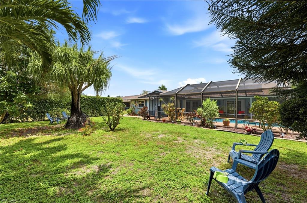 Back of yard looking towards pool cage