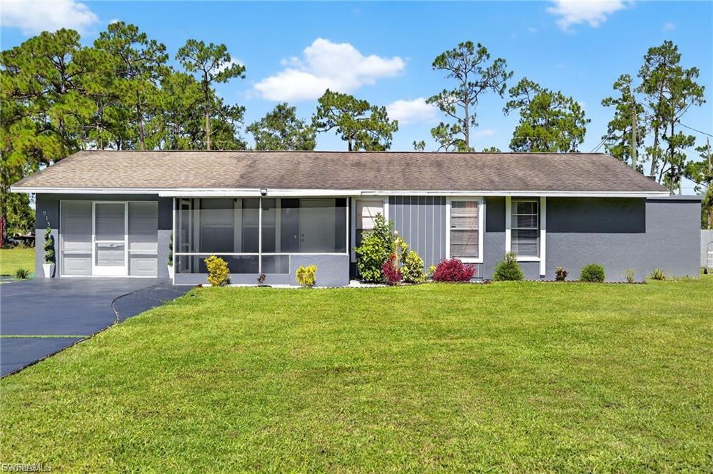 Ranch-style exterior with a screened porch, covered entry, and a paved driveway