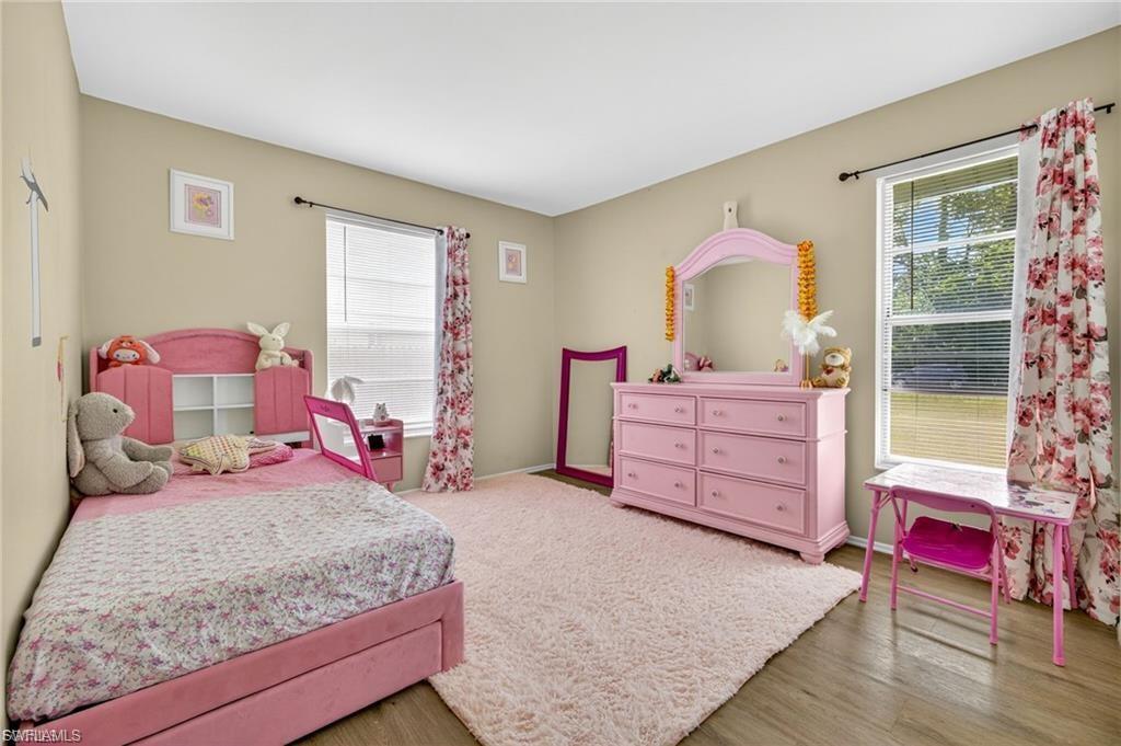 Neutral painted walls complement wood-finish flooring in this room