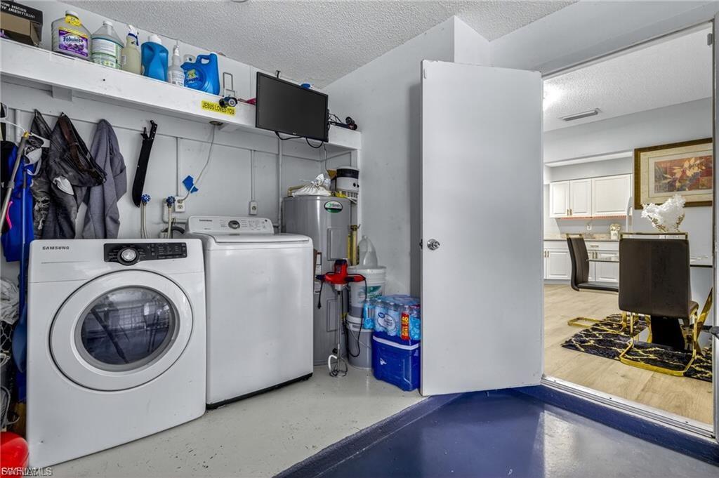 Dedicated laundry area featuring a front-load washer and top-load dryer