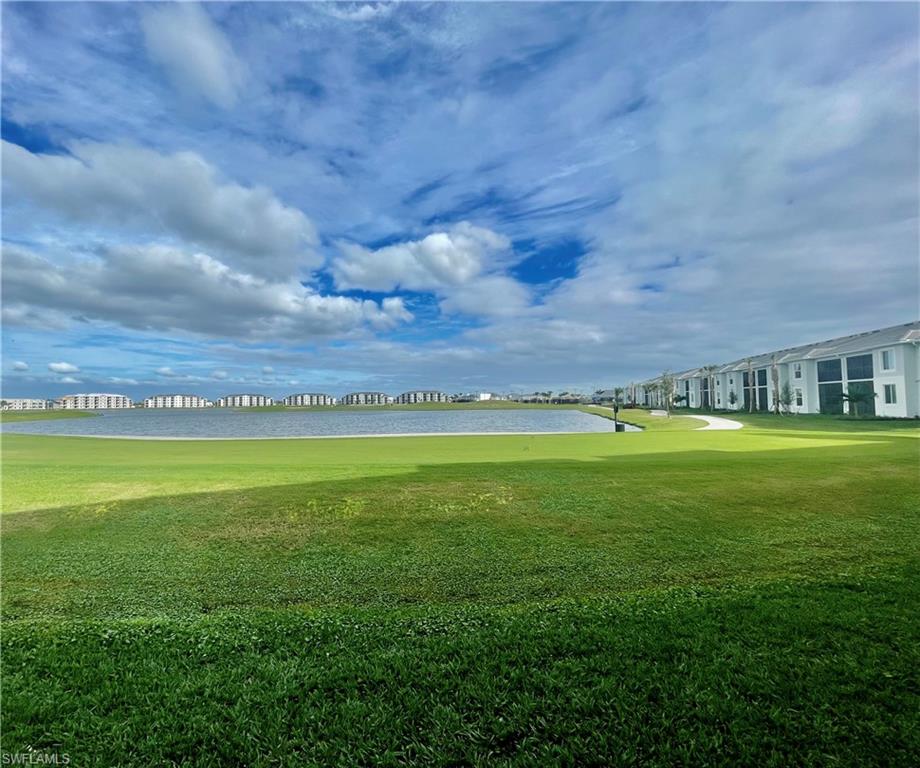 Surrounding community with a yard and a water view