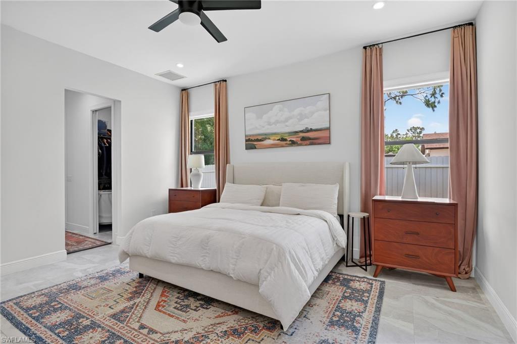 Bedroom featuring light-toned flooring, recessed lighting, and a ceiling fan
