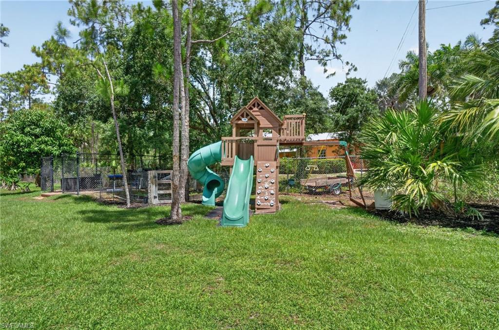 Expansive green lawn featuring a fenced perimeter