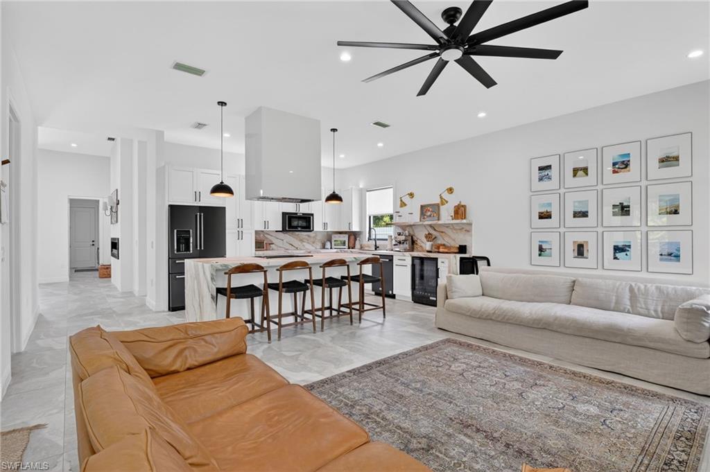Open-concept living area with light-toned tile flooring throughout