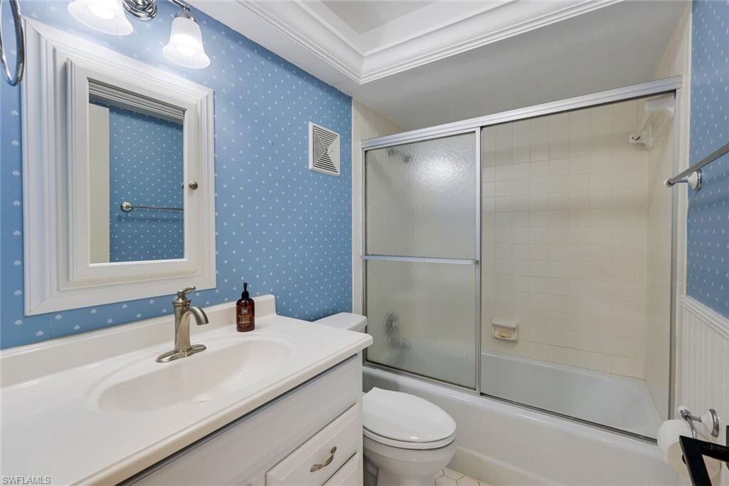 Bathroom featuring a single vanity with a white countertop and integrated sink, a brushed nickel faucet, and a wall-mounted mirror