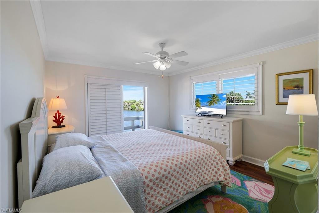 Waterfront access from a private balcony, complemented by crown molding and wood-finish flooring