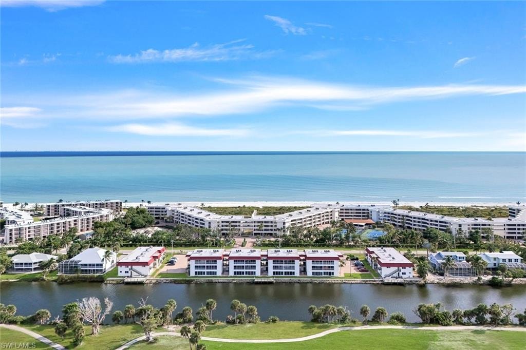Coastal properties featuring direct beach access, canal frontage, manicured golf greens, and multi-story condominium buildings with balconies