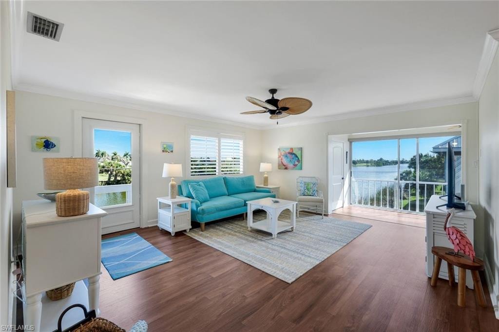Living area featuring wood-finish flooring and crown molding